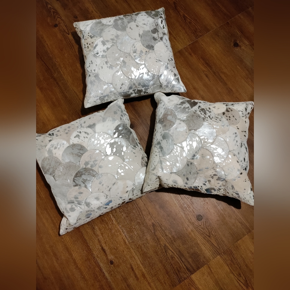 Pillows with pieces of genuine cowhide.